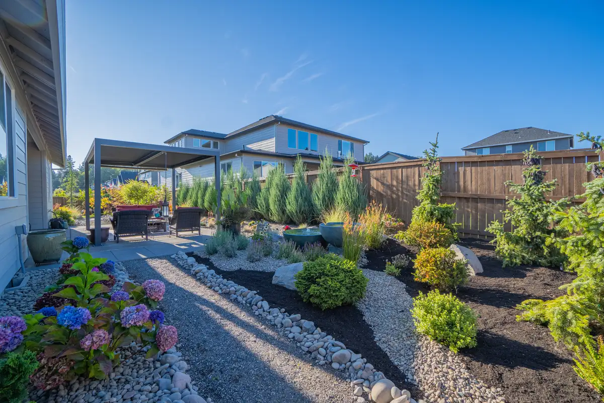 Backyard landscaping with pergola and hydrangeas by CreekView Landscape in Lake Oswego Oregon
