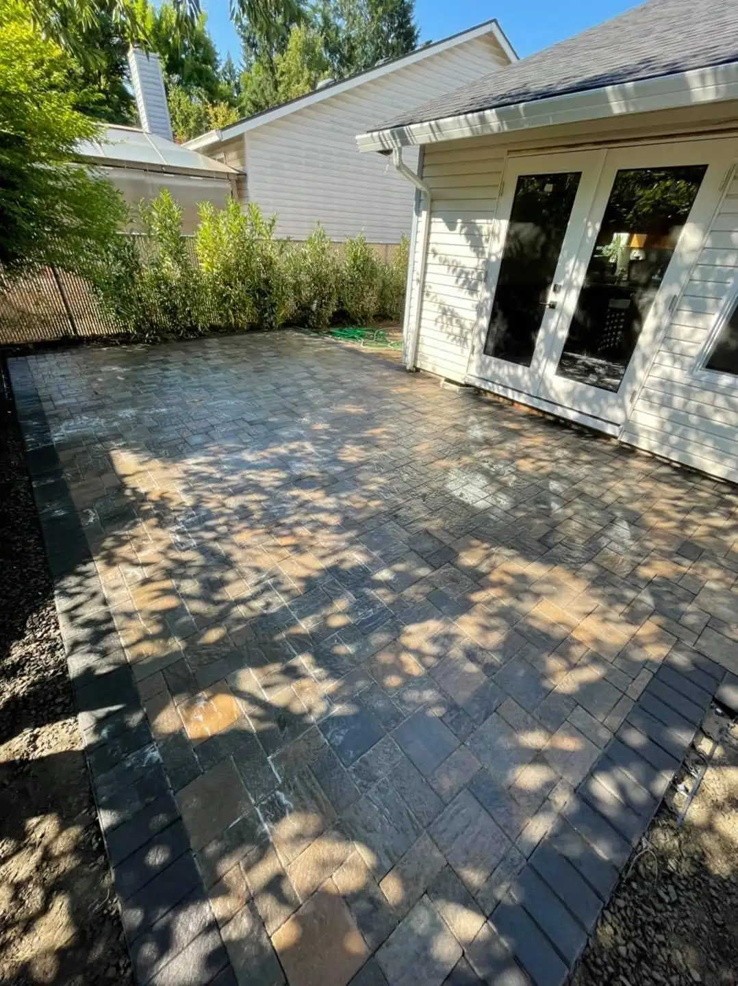 Expansive natural stone paver patio installation in Wilsonville Oregon by CreekView Landscape