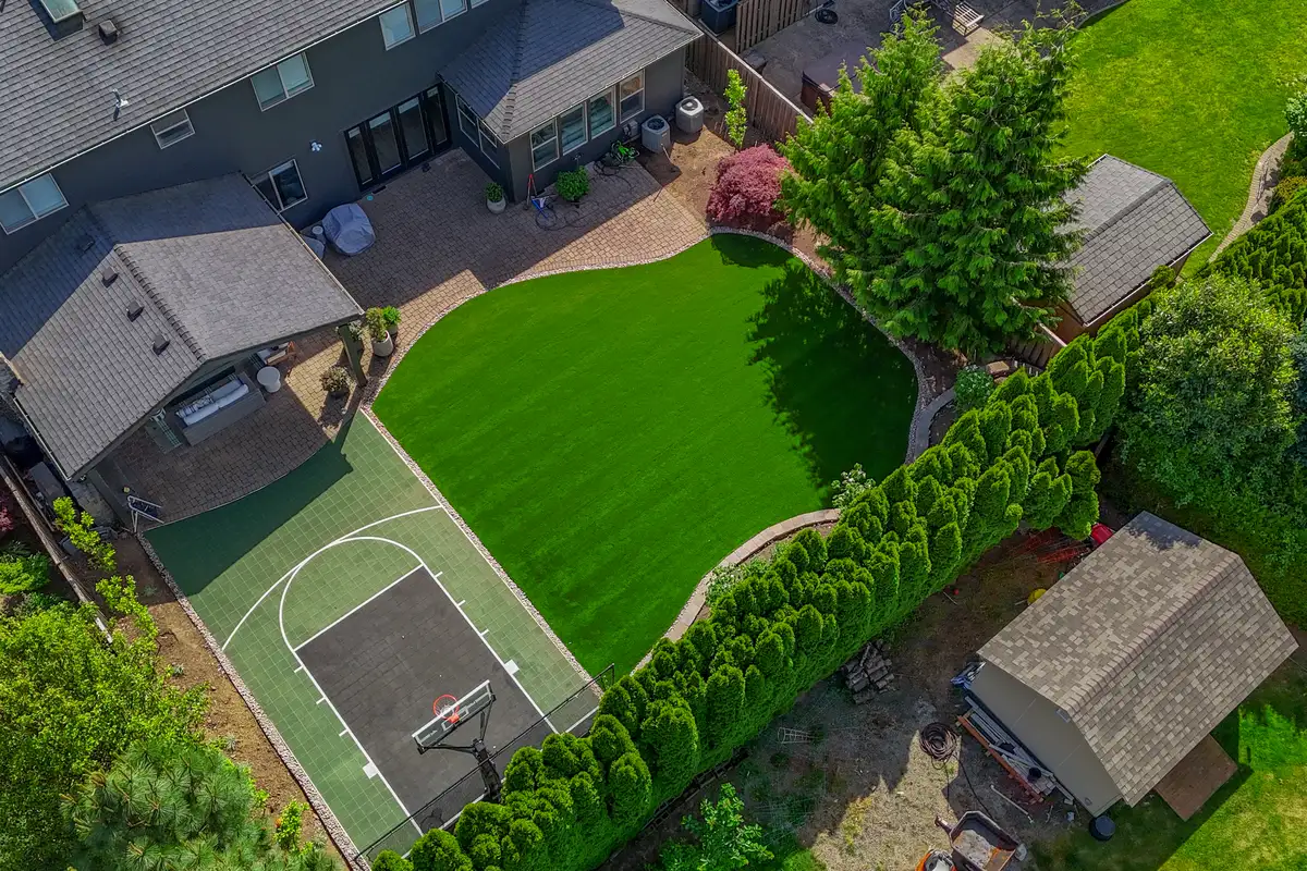Aerial view of complete backyard remodel with turf by CreekView Landscape in Oregon